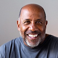 Closeup of senior man in gray shirt smiling