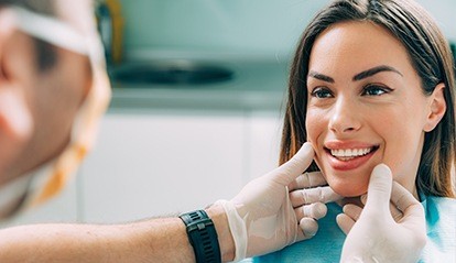 Dentist examining woman's smile