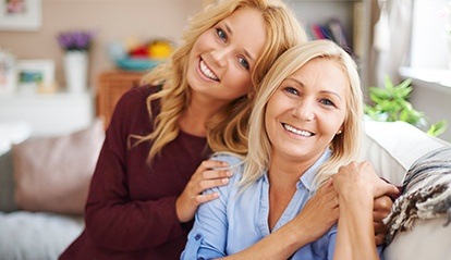 Smiling mother and adult daughter