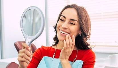 Woman looking at smile in mirror