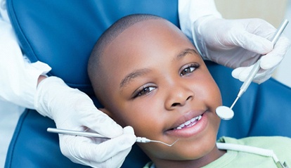 little boy getting dental exam 