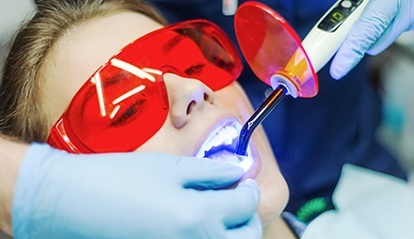 Woman receiving in office teeth whitening