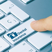 Patient in St. Albans checking dental insurance for dental crown coverage