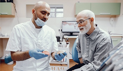 Dentist talking to patient about dentures