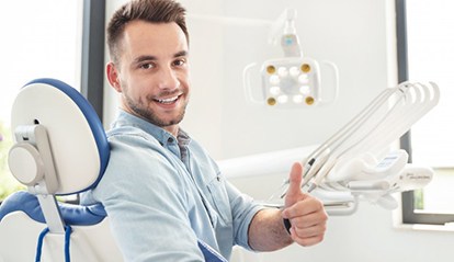 man giving thumbs up before getting tooth extractions in St. Albans 