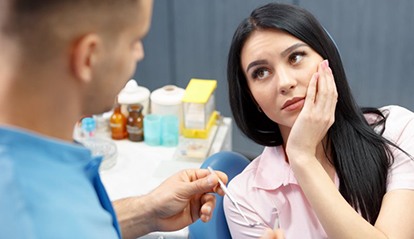 woman with toothache talking to her dentist 