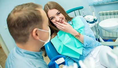 woman getting tooth-colored filling hardened with curing light 