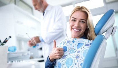 young woman laughing in dental chair 
