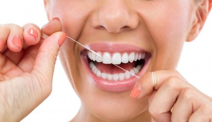 close up of woman flossing 