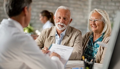 elderly couple at an implant dentures consultation