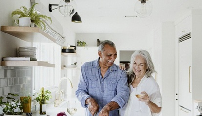 elderly couple cooking together