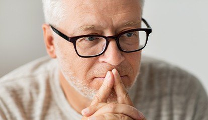 Man with glasses thinking