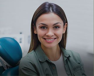 Smiling young woman in dental chair