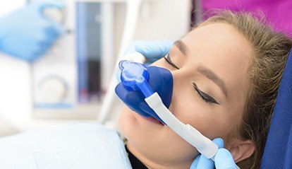 Woman with nitrous oxide nose mask