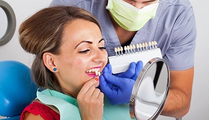 woman in red shirt trying on veneers in St. Albans 