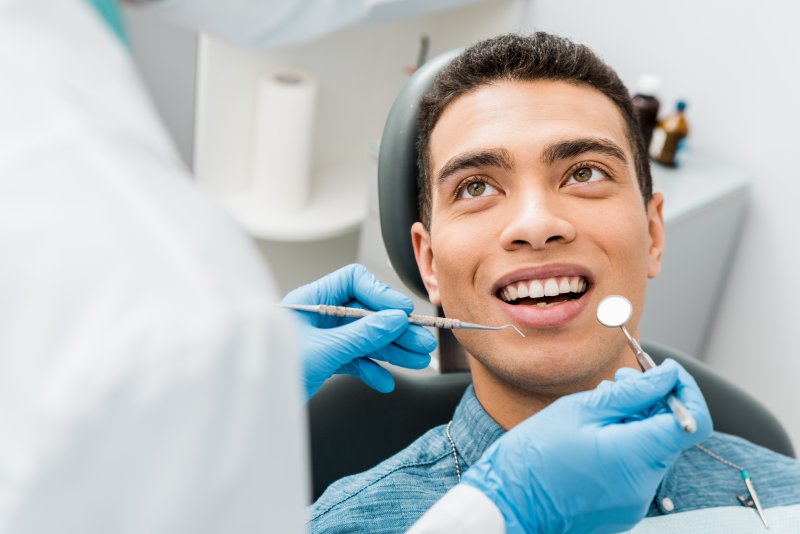 young man smiling at dental checkup