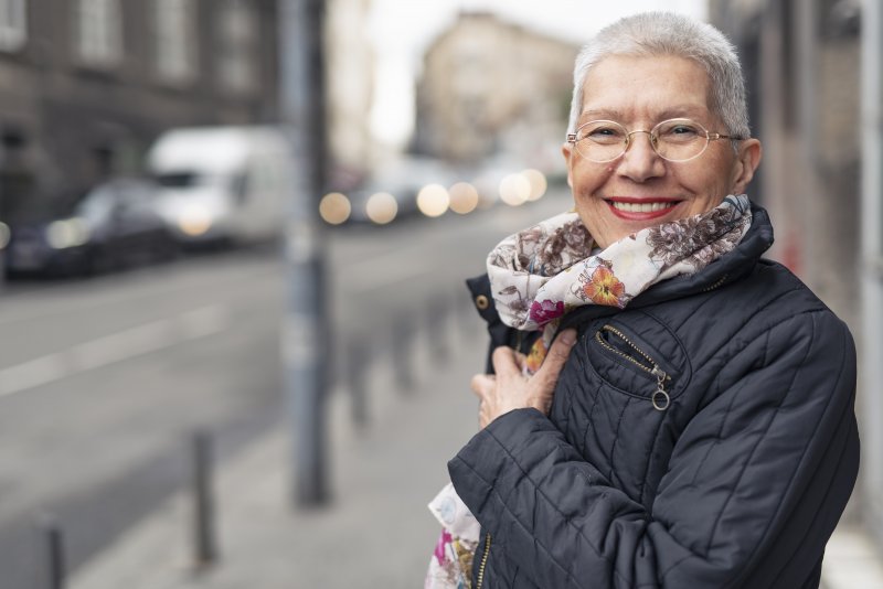 Woman smiling after seeing cosmetic dentist