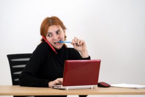 woman chewing on pen