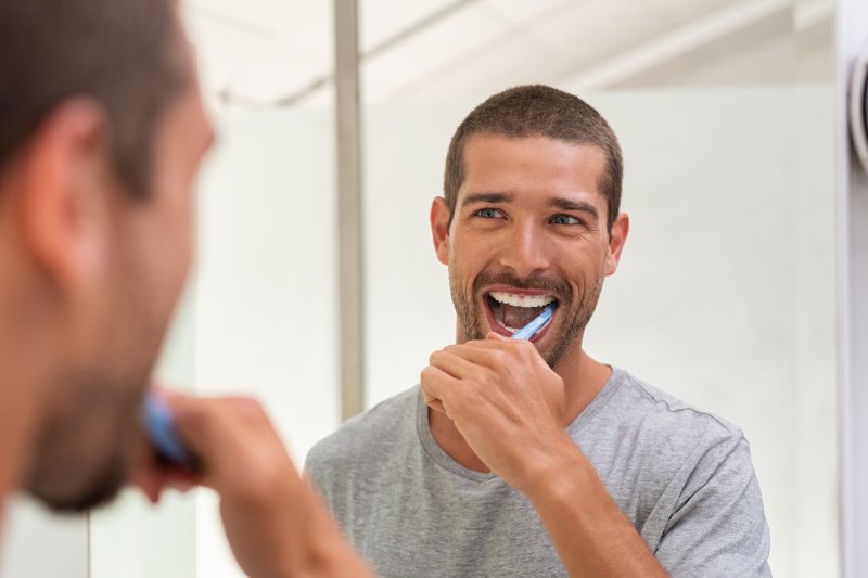 man flossing teeth 