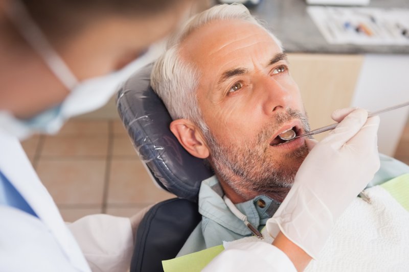 mature man getting dental checkup 