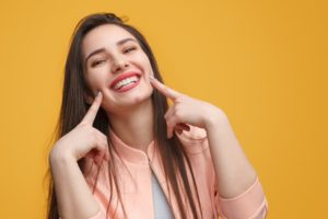 A patient pointing to her smile in St. Albans