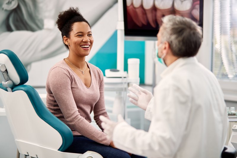 dentist talking to patient about dental implants
