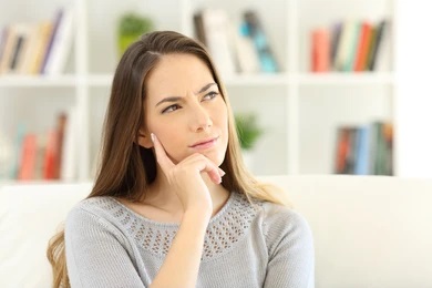 puzzled person questioning if white teeth are always healthy teeth