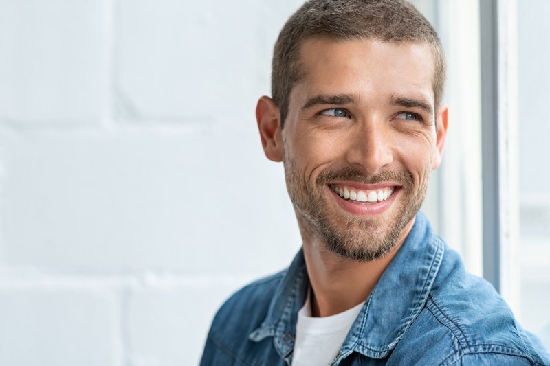 A happy and smiling man looking away