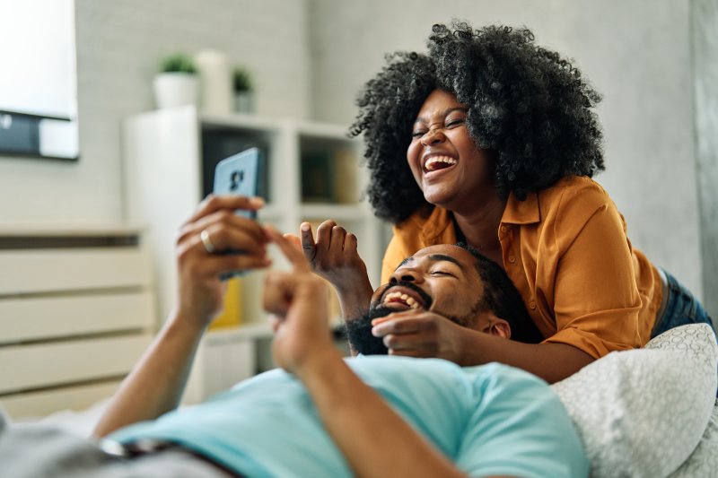 A couple taking a happy selfie with a cell phone