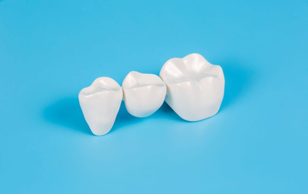 Dental bridge on light blue background